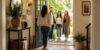Homeowners welcoming guests at the front door of a bright contemporary entryway, illustrating the first things guests notice about your home.
